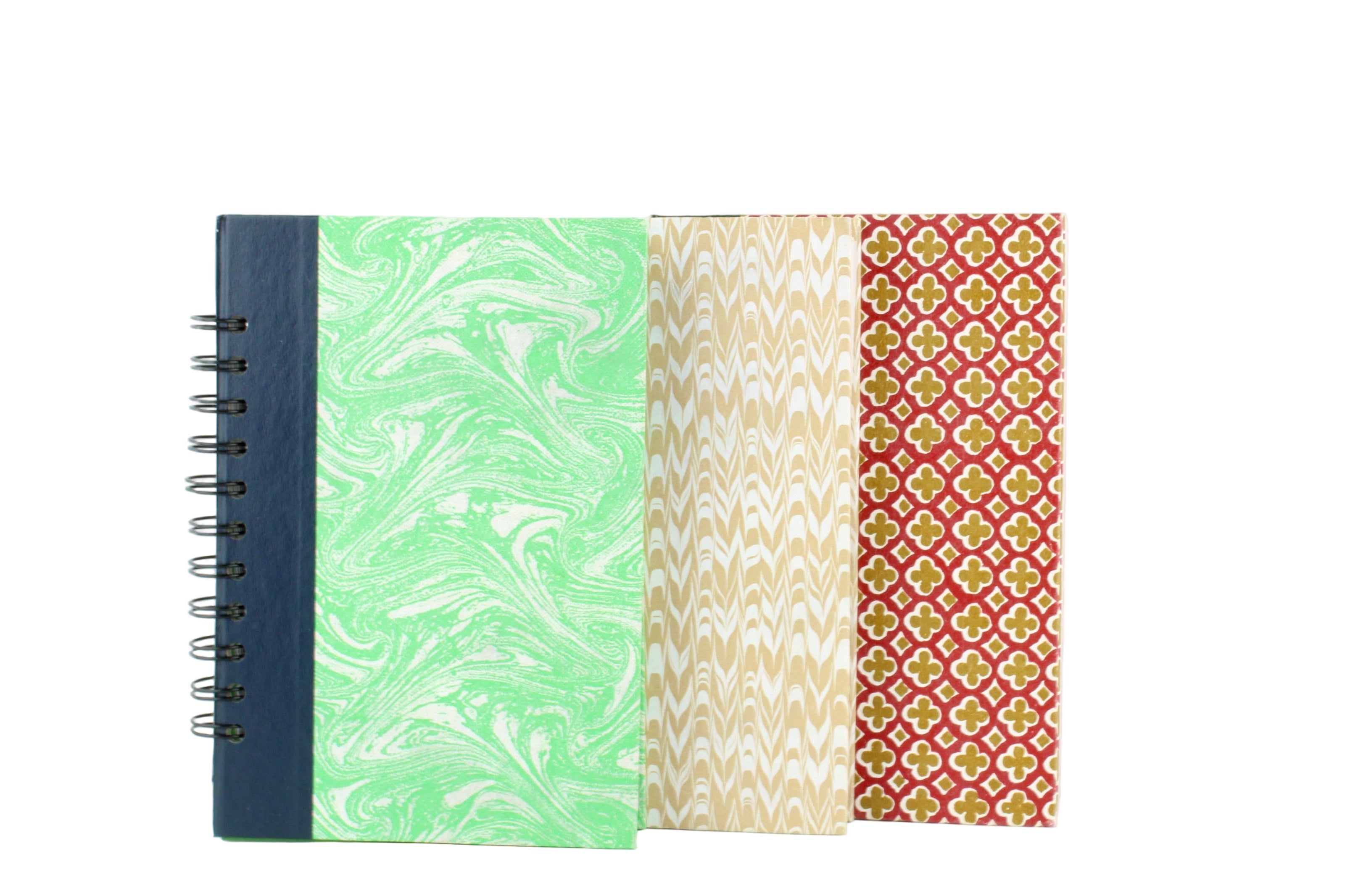 Three notebooks with different patterns on a white background