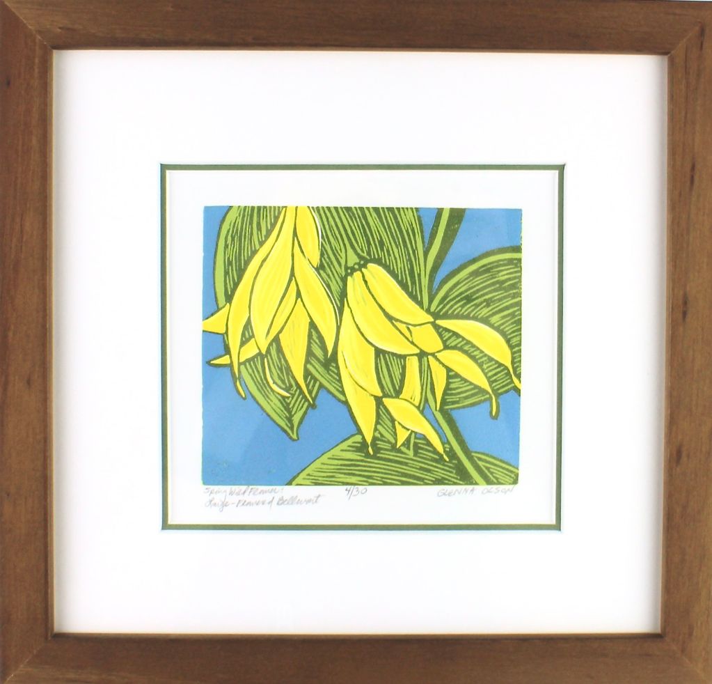 Framed artwork of yellow flowers and green leaves on a blue background