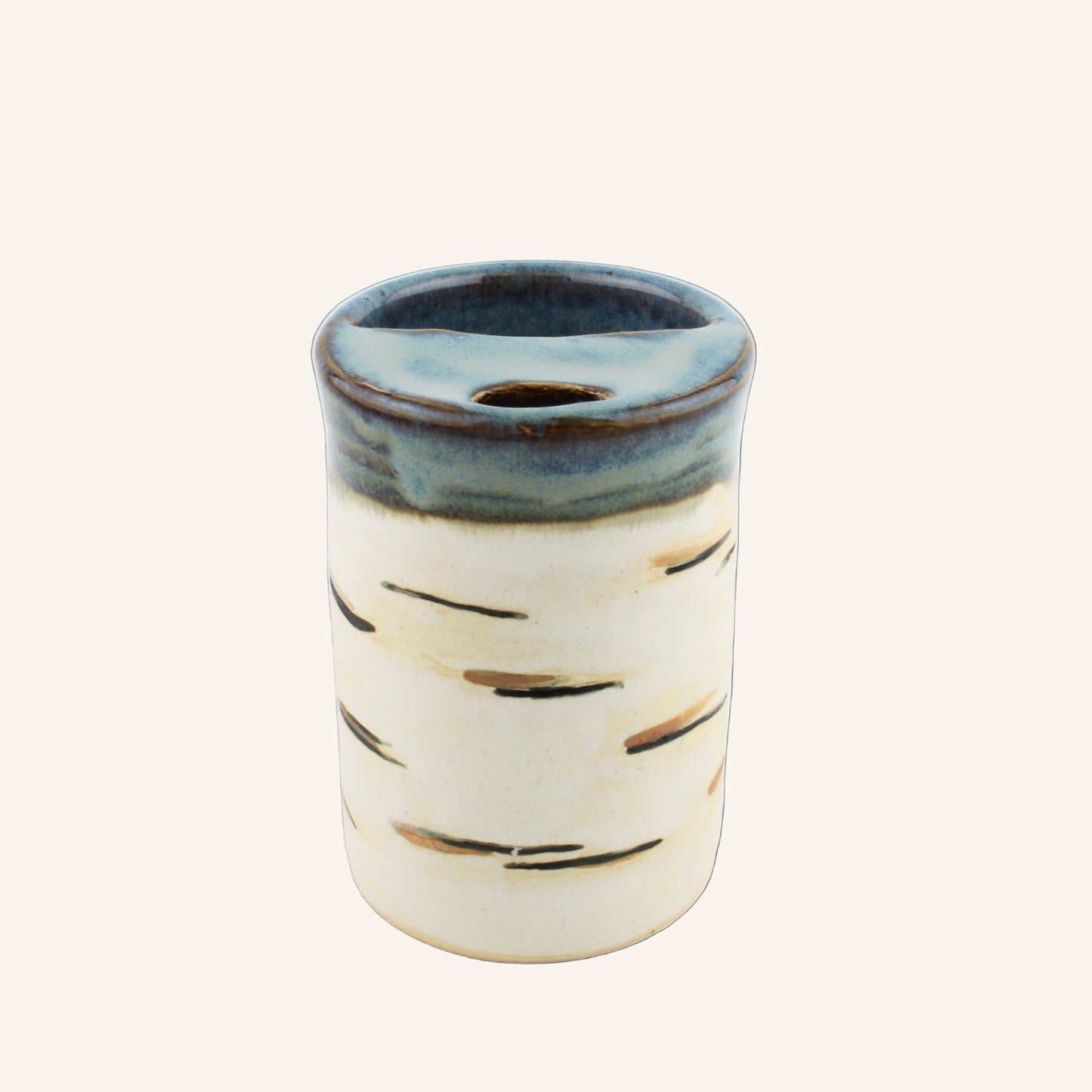 Ceramic tumbler with blue rim and white body on a white background