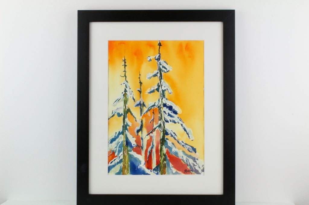 Snow Covered Pine Against an Orange Sky