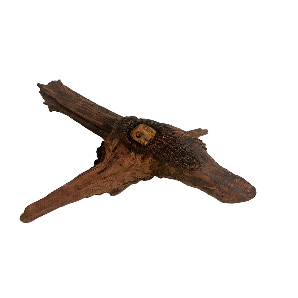 A sculpture made of driftwood with a natural brown finish, shaped in an abstract manner.