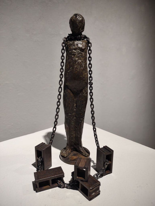 Figure Chained to Cement Blocks